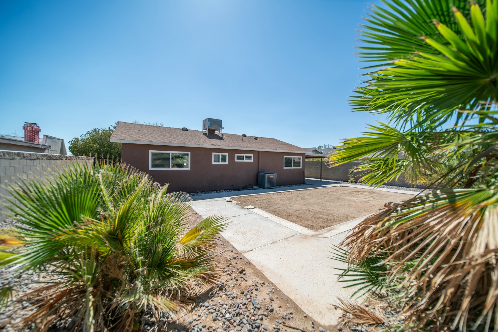 Single-story Buckeye home with palm and bermuda lawn out front