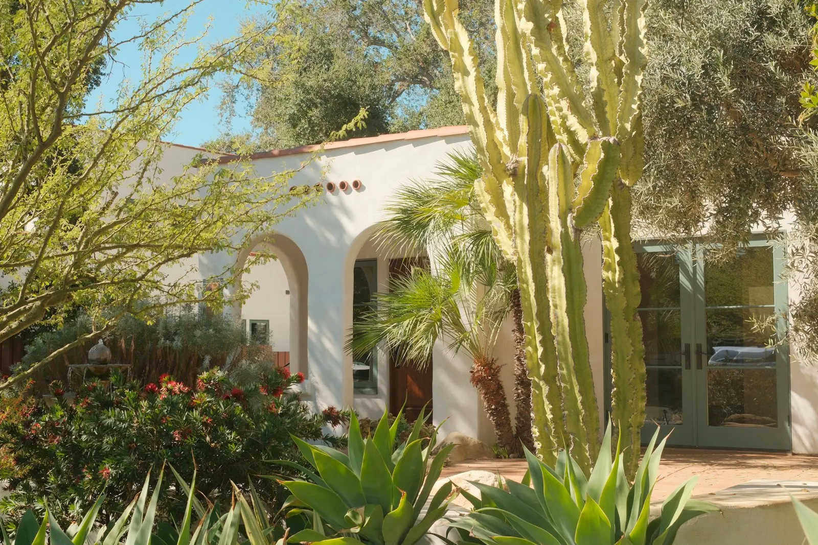 Spanish-style West Valley home with paver walkway, palms, and DG front yard